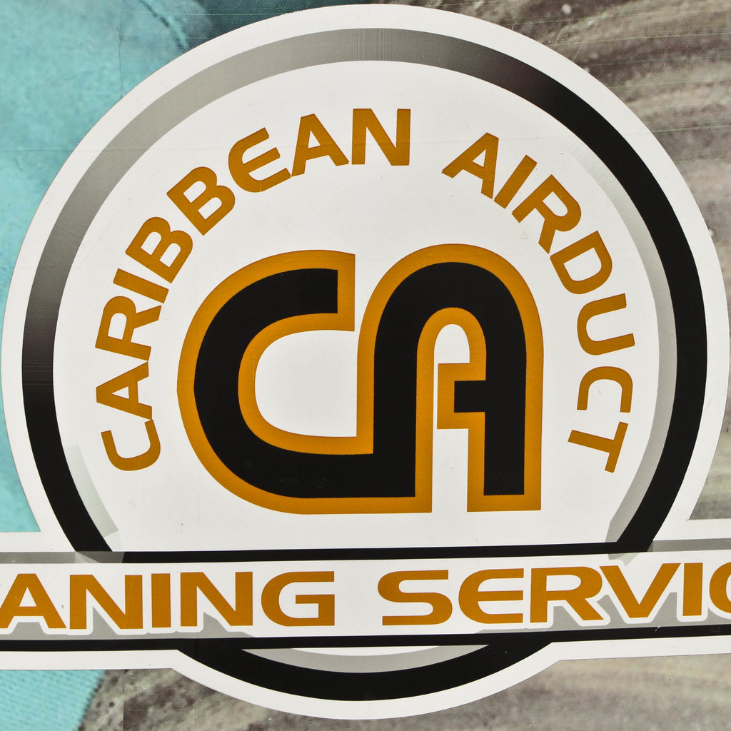 Professional air duct cleaning technician working in a home